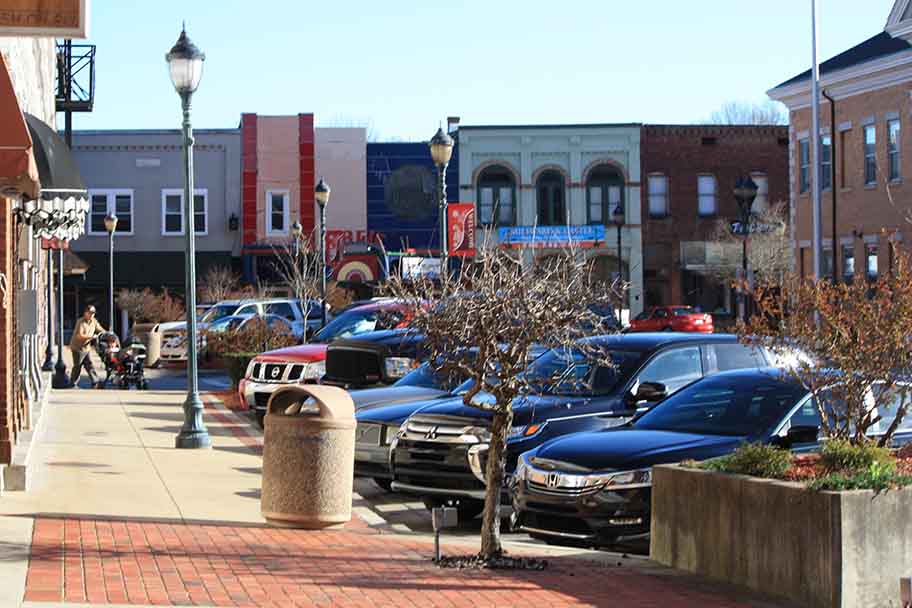 main street looking along sidewalk and storefronts